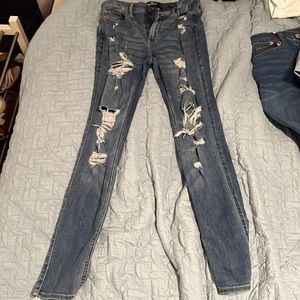 Two pairs of jeans. Blue- Hollister. Black- American eagle